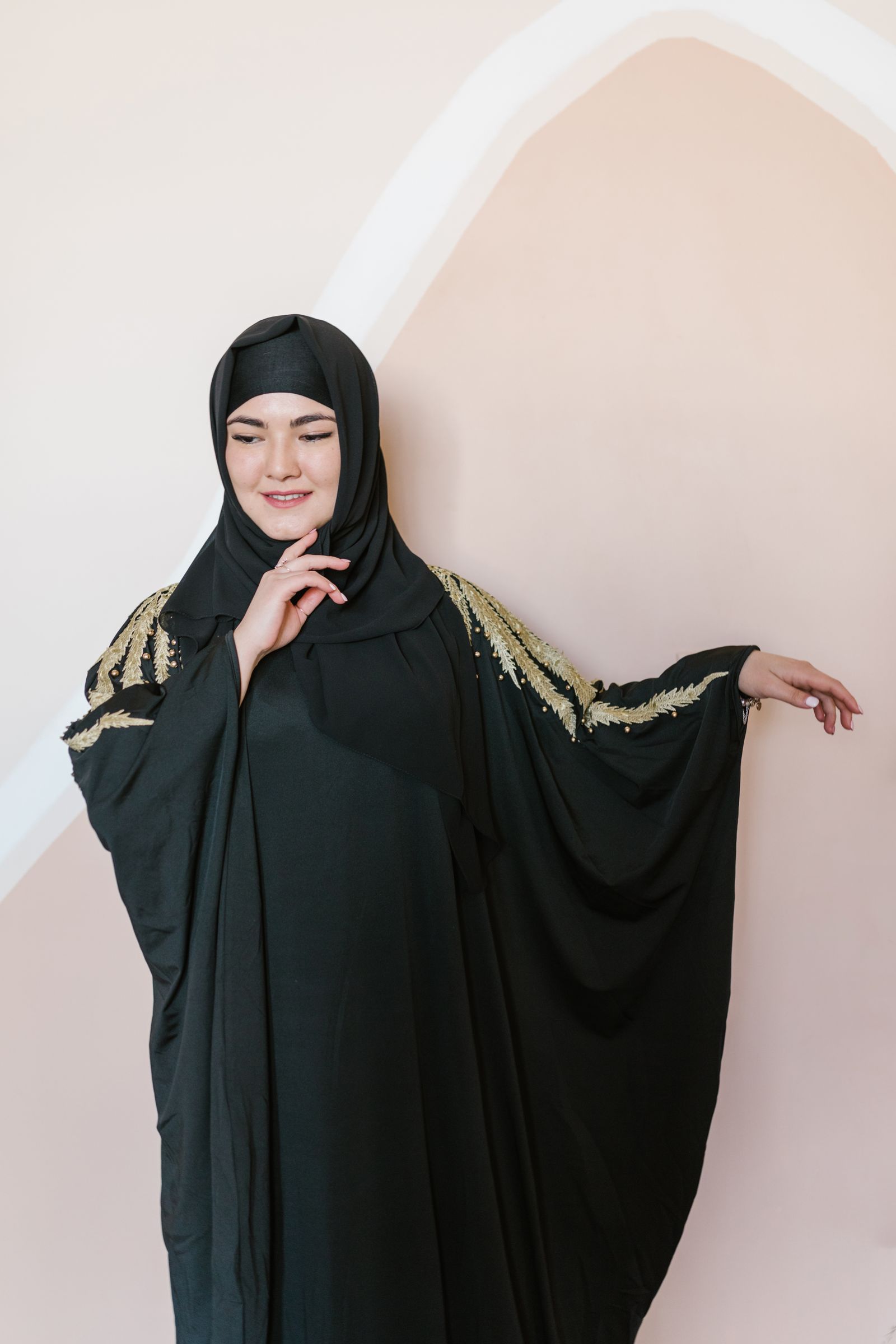 Model in a camel abaya with delicate embroidery