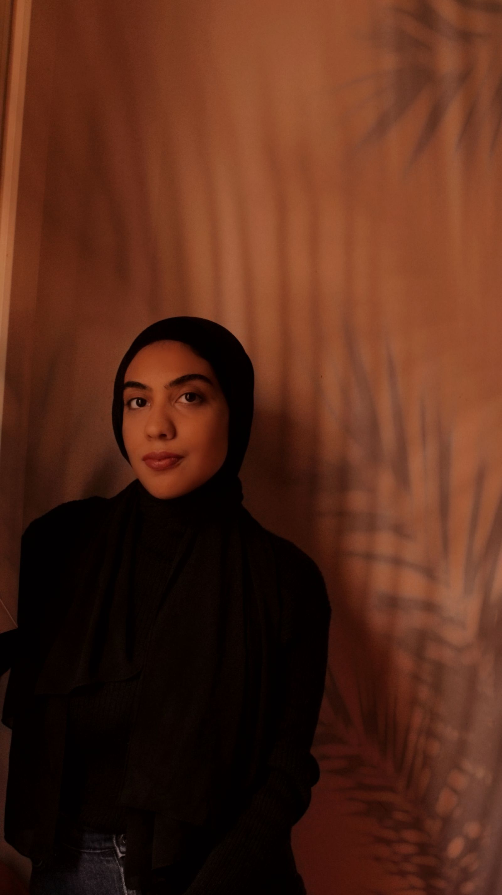 Close portrait of a model in an embroidered neutral abaya