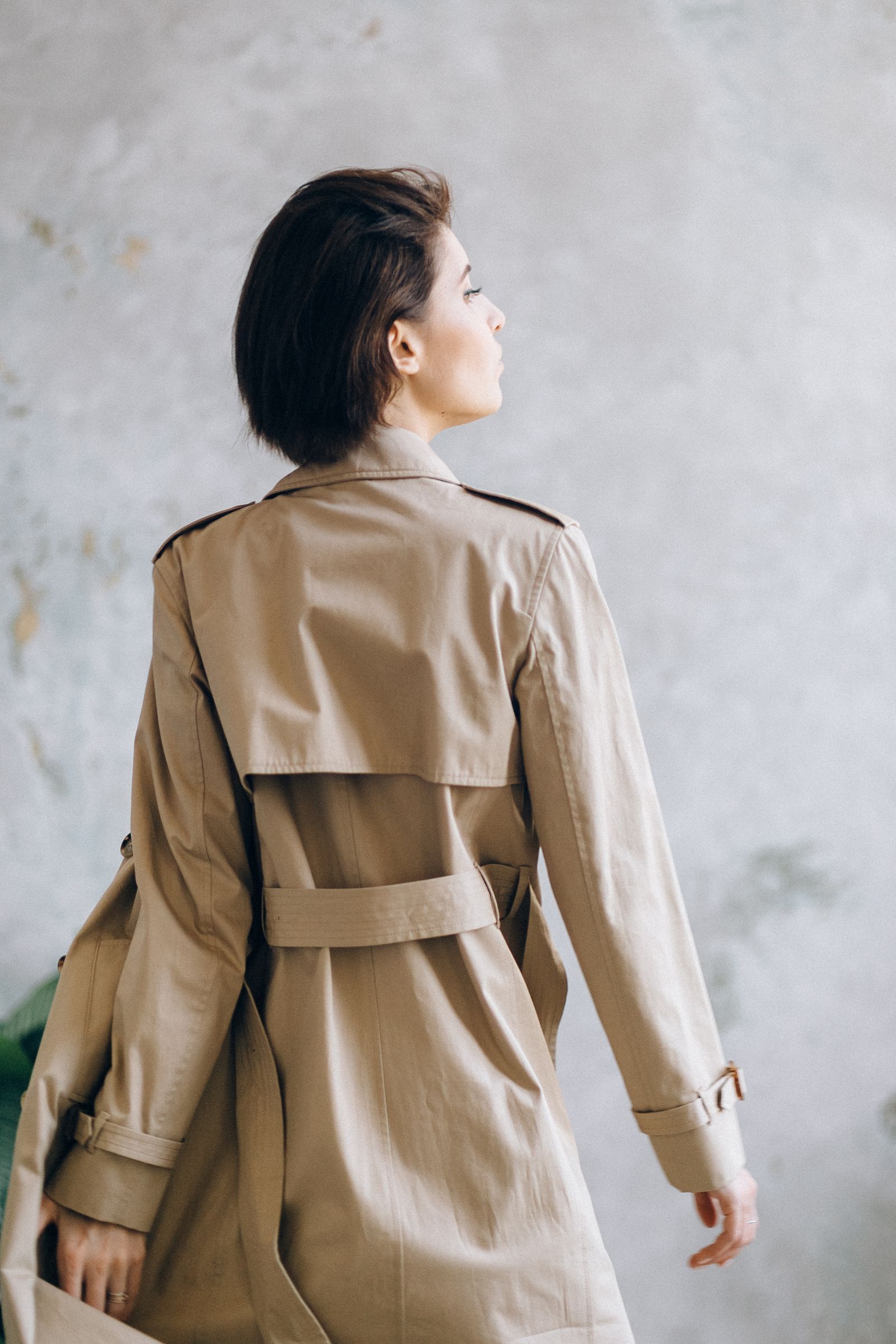 Model in a sand trench-inspired coat, back view